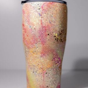 Side angle of the 30oz Neon Galaxy Tumbler showcasing the curved design and swirling neon glitter pattern. This stainless steel tumbler is double-wall insulated, making it both stylish and functional for everyday use.