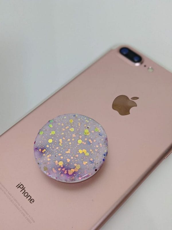 Speckled Opal phone grip placed on rose gold iphone